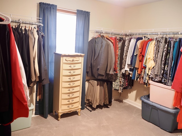 spacious closet featuring light colored carpet