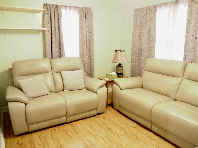 living room featuring plenty of natural light and light hardwood / wood-style flooring