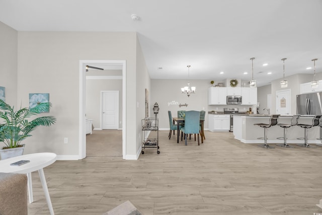 interior space featuring sink, a chandelier, and light hardwood / wood-style floors