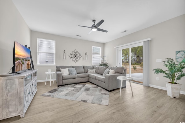 living room featuring ceiling fan and light hardwood / wood-style flooring