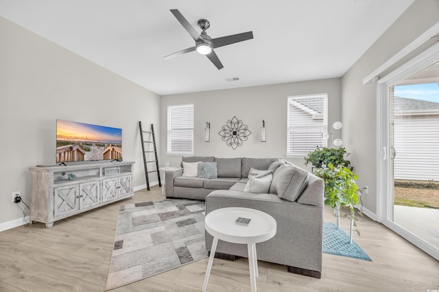 living room with ceiling fan and light wood-type flooring