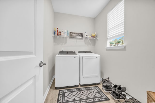 washroom featuring separate washer and dryer and light wood-type flooring