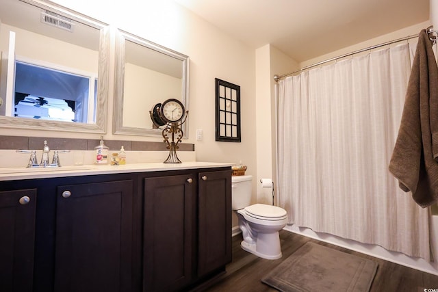 bathroom featuring hardwood / wood-style flooring, vanity, toilet, and walk in shower