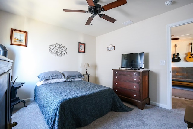 bedroom featuring light colored carpet and ceiling fan