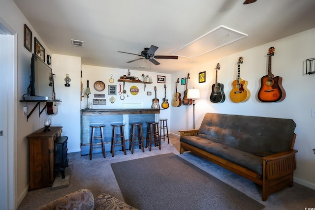 carpeted living room with bar and ceiling fan