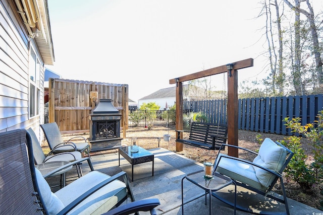 view of patio / terrace featuring exterior fireplace