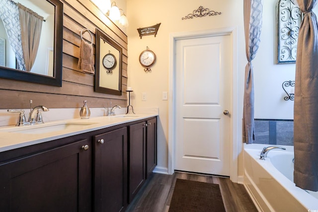 bathroom featuring a bathing tub, hardwood / wood-style floors, and vanity