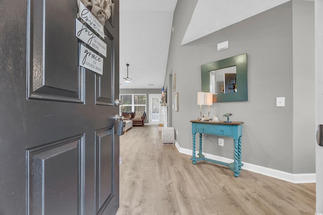 foyer featuring light wood finished floors and baseboards