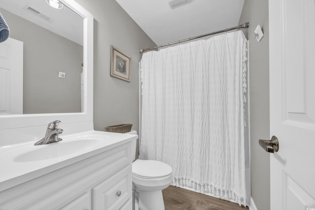 bathroom with vanity, toilet, and hardwood / wood-style floors