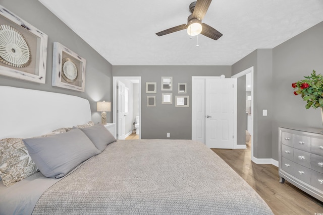 bedroom featuring ensuite bathroom, ceiling fan, and light hardwood / wood-style floors