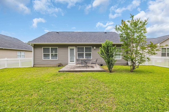 back of property with a patio area and roof with shingles