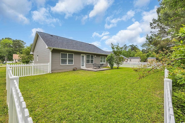 back of property with a patio area and a shingled roof
