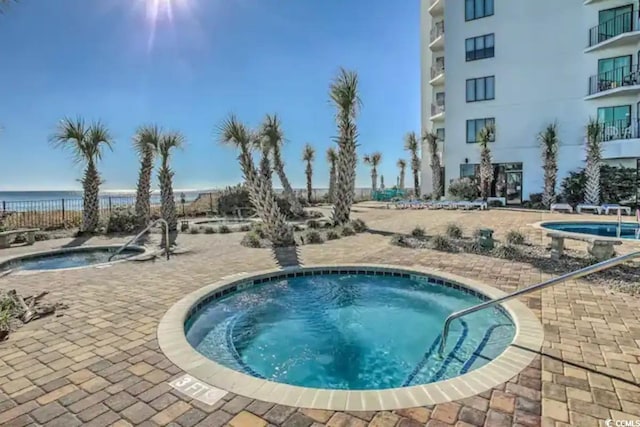 1605 S Ocean Blvd Unit 1602, Myrtle Beach, SC 29577 - view of swimming pool featuring a hot tub