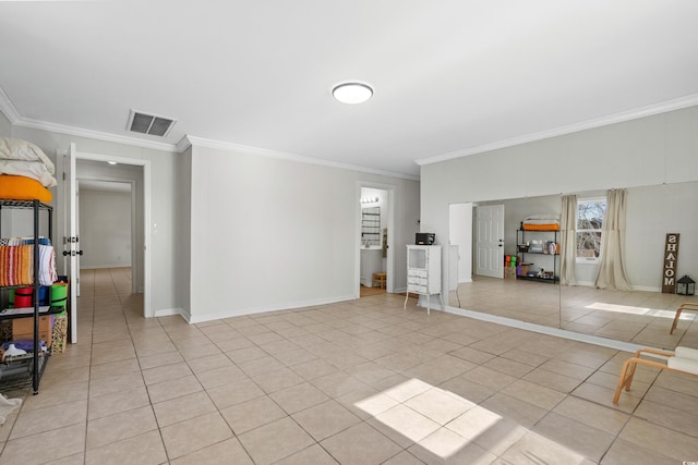 interior space with ornamental molding and light tile patterned floors