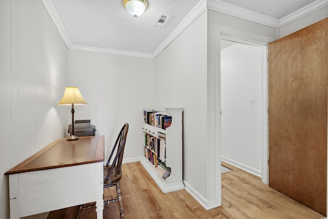 home office featuring light hardwood / wood-style flooring and crown molding