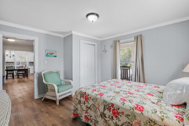 bedroom with crown molding and dark wood-type flooring