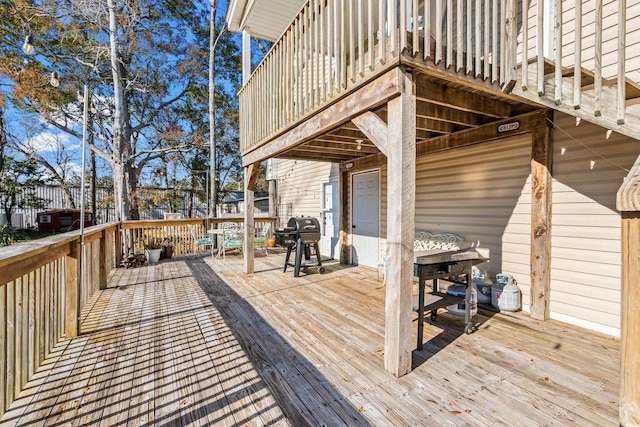 wooden terrace with a grill