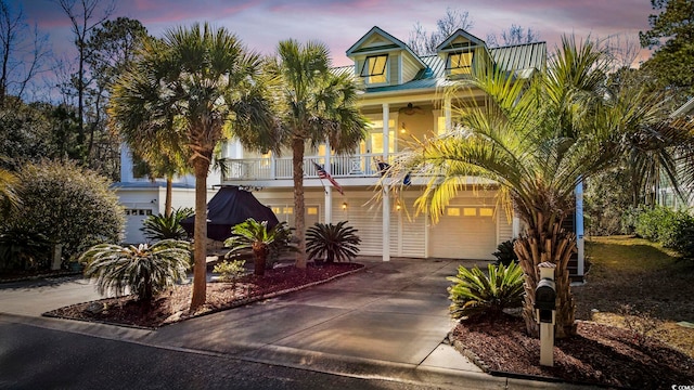 view of front of property with a garage and a balcony