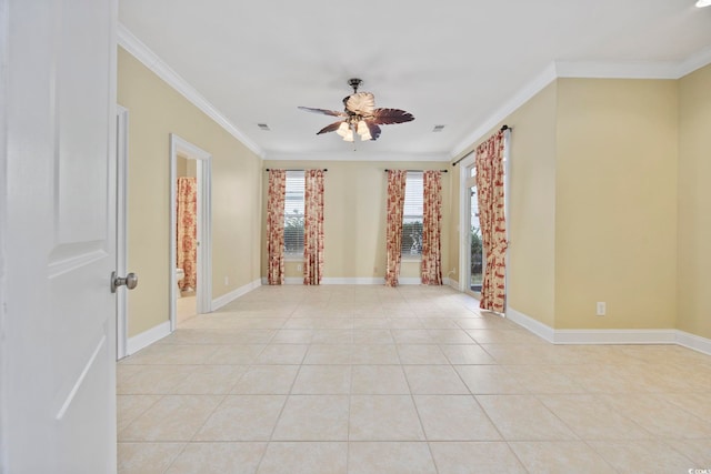 spare room featuring light tile patterned flooring, ceiling fan, and crown molding