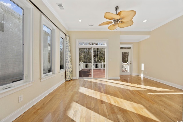 unfurnished sunroom featuring ceiling fan