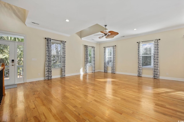 unfurnished living room with crown molding and light hardwood / wood-style floors