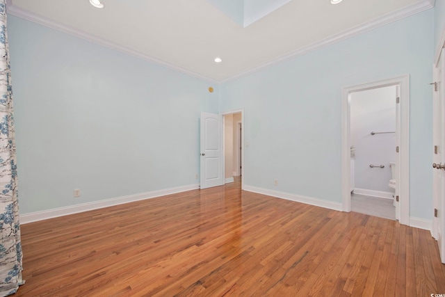 unfurnished room featuring crown molding and light wood-type flooring