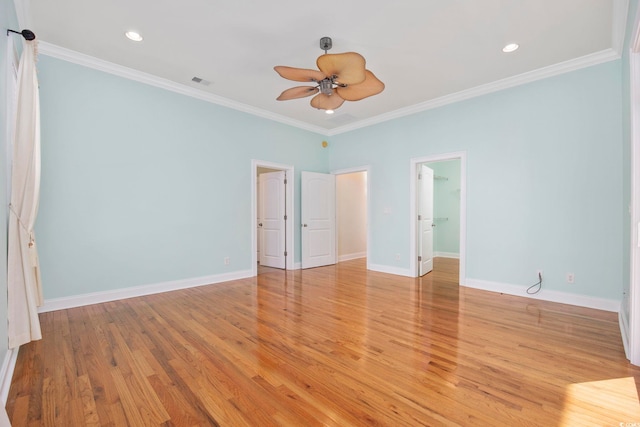 spare room featuring ornamental molding, ceiling fan, and light wood-type flooring