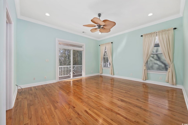 spare room with hardwood / wood-style floors, crown molding, and ceiling fan