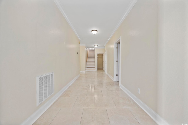 corridor featuring ornamental molding and light tile patterned flooring