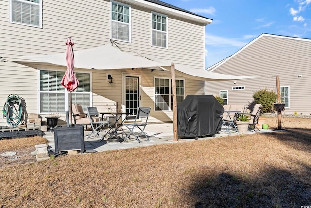 rear view of house featuring a patio area and a lawn