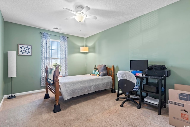 carpeted bedroom with visible vents, ceiling fan, a textured ceiling, and baseboards