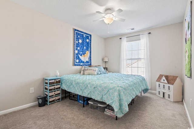 bedroom with a textured ceiling, carpet, visible vents, and baseboards