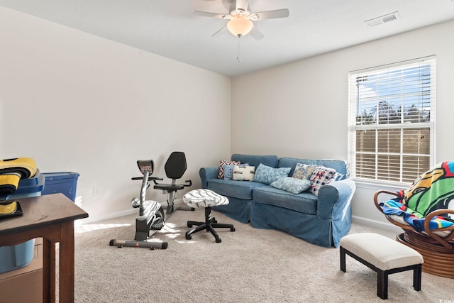 interior space with baseboards, visible vents, and a ceiling fan