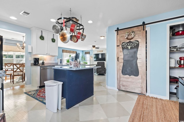 kitchen featuring a barn door, a kitchen island, visible vents, white cabinetry, and dishwasher