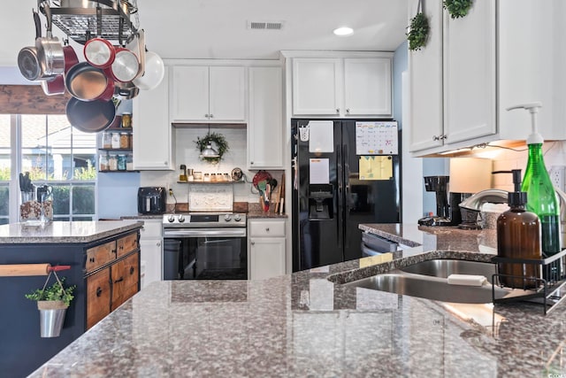 kitchen featuring stainless steel appliances, a sink, visible vents, and white cabinetry