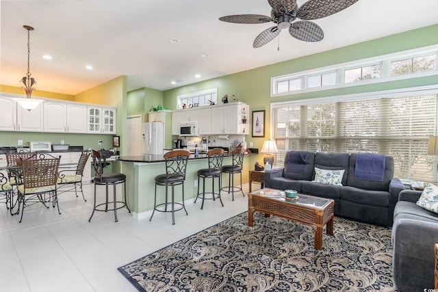 tiled living room featuring ceiling fan