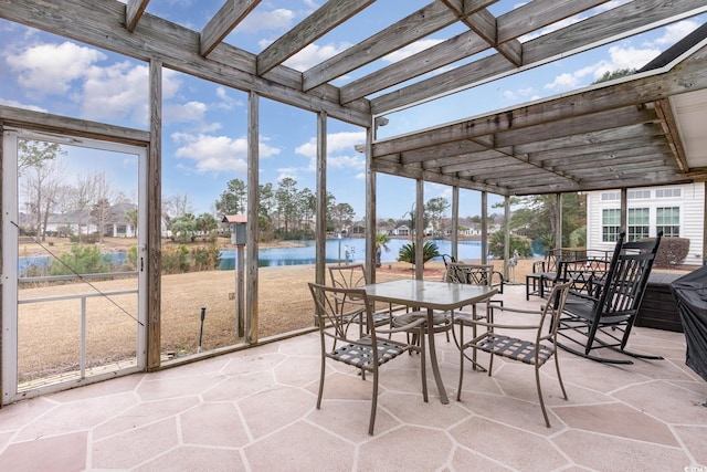 unfurnished sunroom featuring a water view and a wealth of natural light