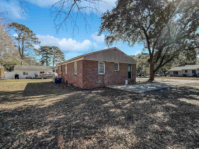 view of property exterior featuring a lawn and a patio