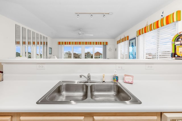 kitchen with sink, rail lighting, and ceiling fan