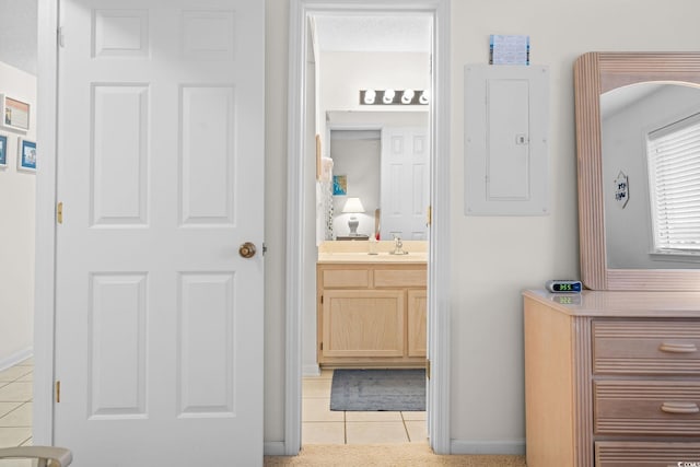 bathroom with tile patterned flooring, vanity, electric panel, and a textured ceiling