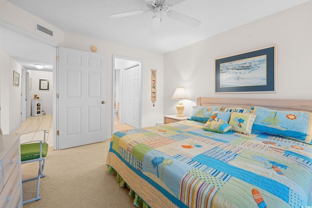 bedroom with light colored carpet, a closet, and ceiling fan