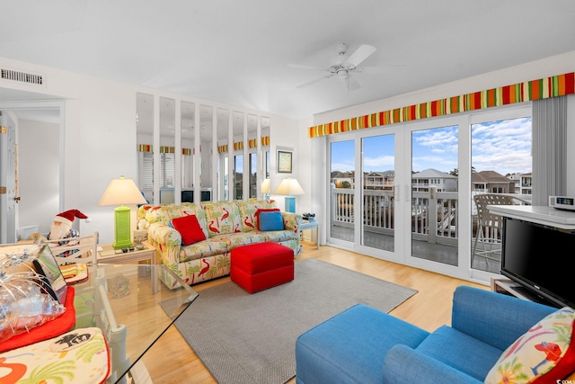 living room with hardwood / wood-style floors, plenty of natural light, and ceiling fan