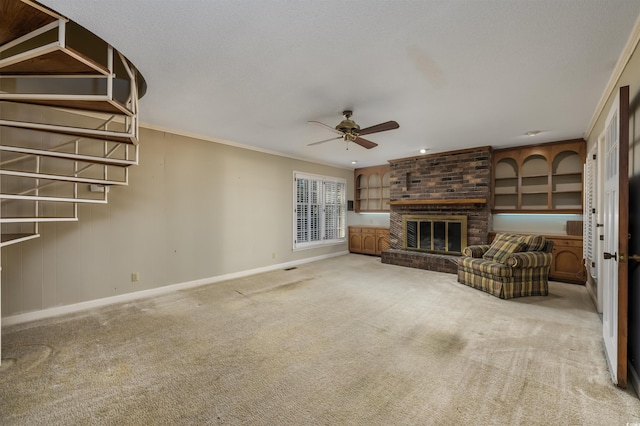 unfurnished living room featuring crown molding, baseboards, carpet, a fireplace, and a ceiling fan