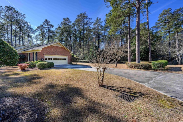 view of front of home featuring a garage, brick siding, and concrete driveway