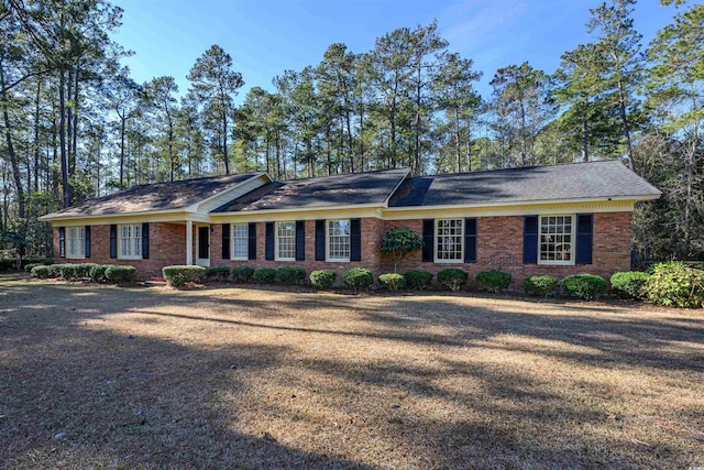 single story home featuring brick siding and a front lawn