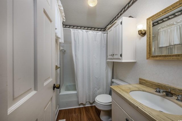 bathroom featuring shower / bathtub combination with curtain, toilet, a textured ceiling, wood finished floors, and vanity