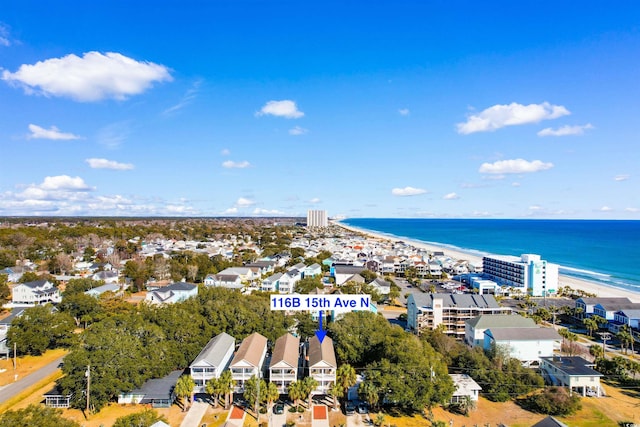 birds eye view of property with a water view and a view of the beach