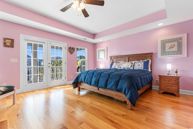 bedroom with ceiling fan, access to exterior, french doors, and light hardwood / wood-style floors