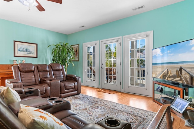 living room with hardwood / wood-style flooring and ceiling fan