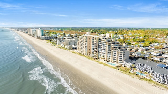 bird's eye view with a water view and a beach view